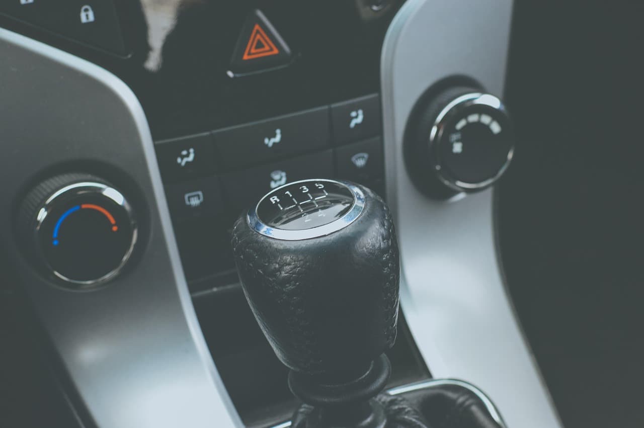 The gear stick and centre console of a manual car